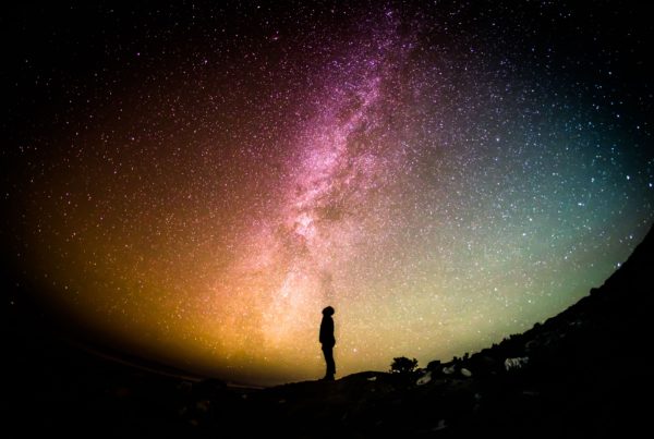 Silhouette of a man gazing at the galaxy