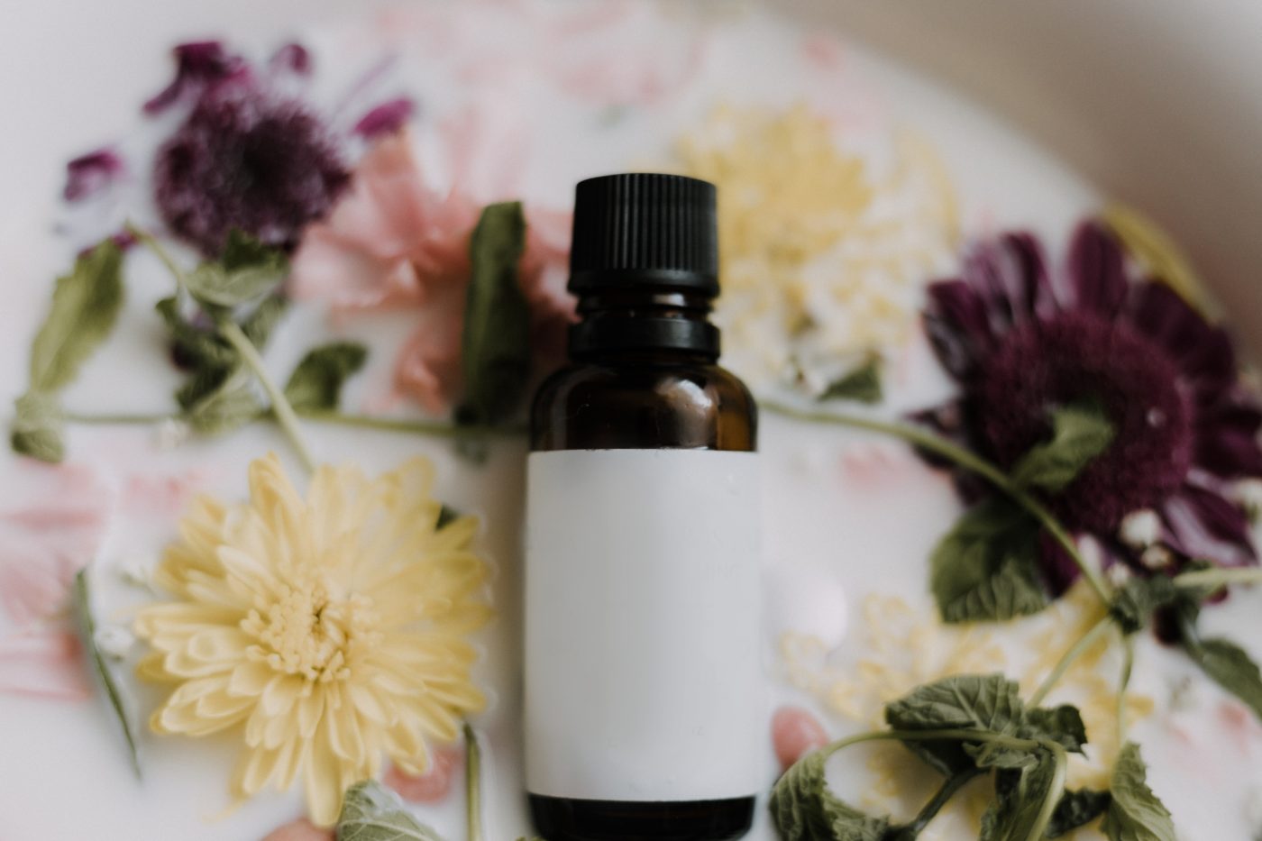 A tincture with flowers around it