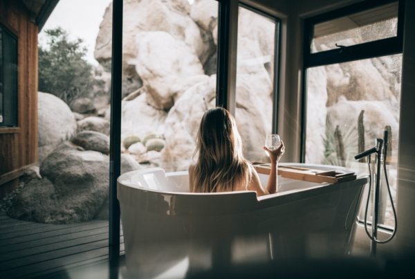A woman lounging in a bathtub on a wellness retreat