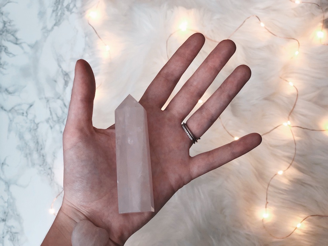 a hand holding rose quartz