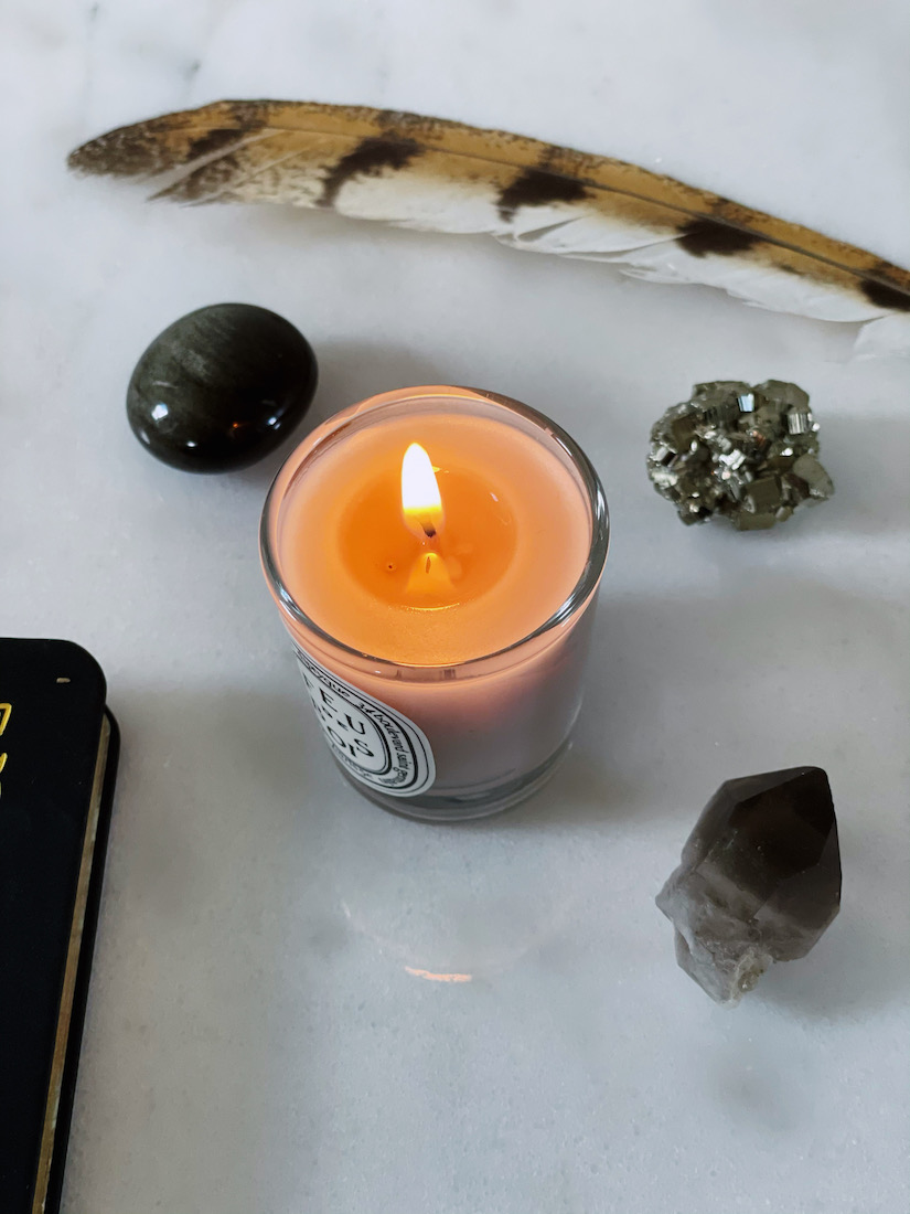 diptyque candle, pyrite, smoky quartz, hawk feather, journal