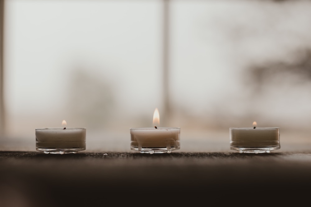 three white tealights on windowsill